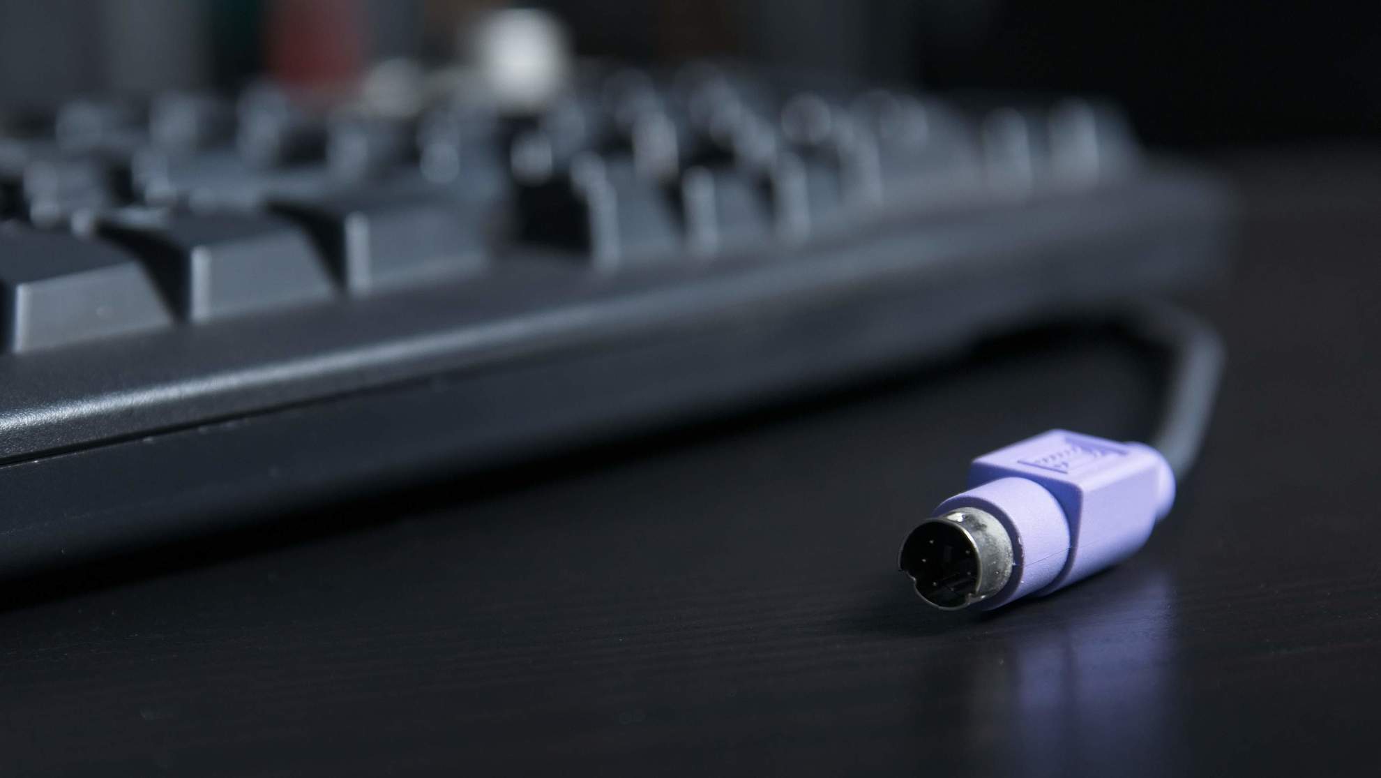 PS2 Keyboard and connector sitting on a desk