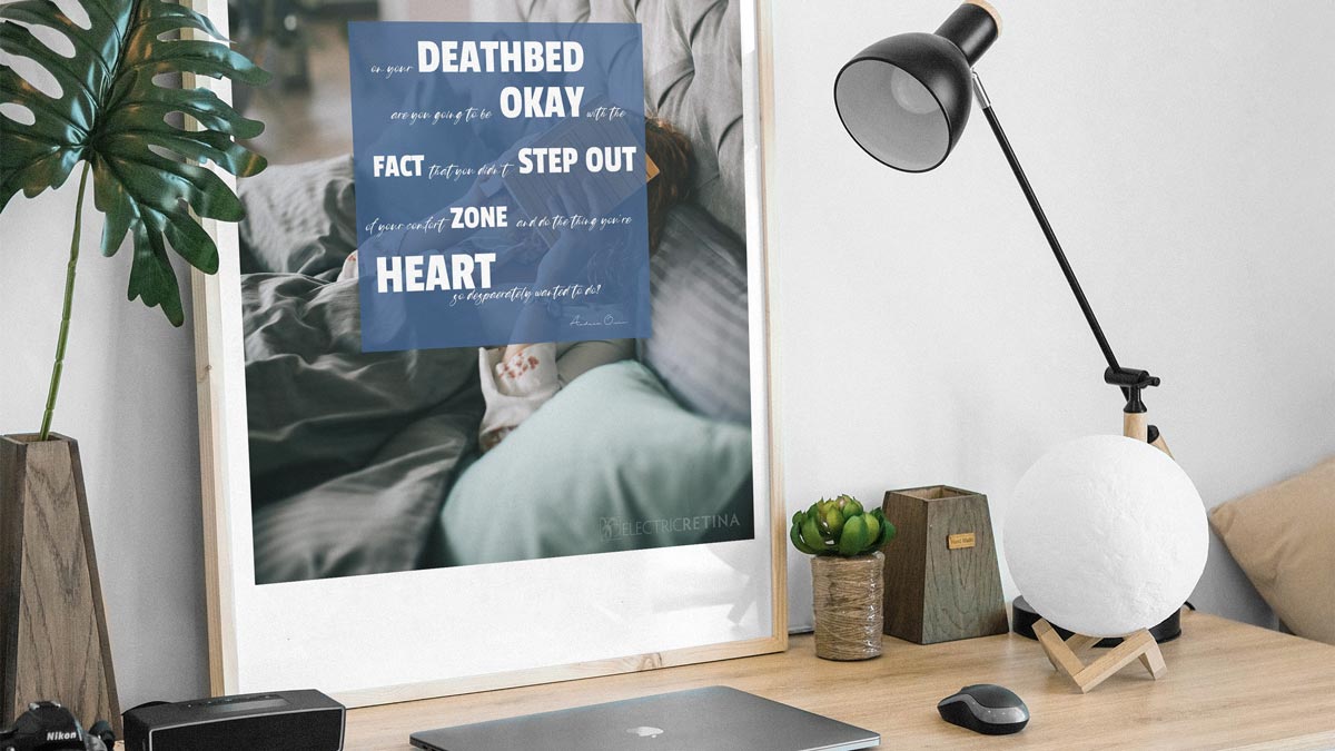 Photo of a home work space with a large poster on the desk with and inspirational quote